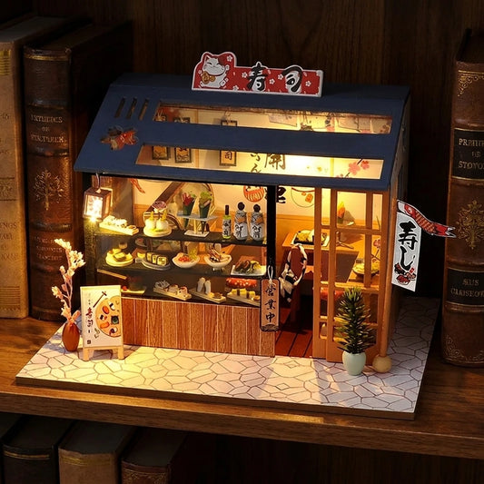 Échoppe à Sushi miniature en bois posée entre des livres, LED allumées en ambiance de nuit