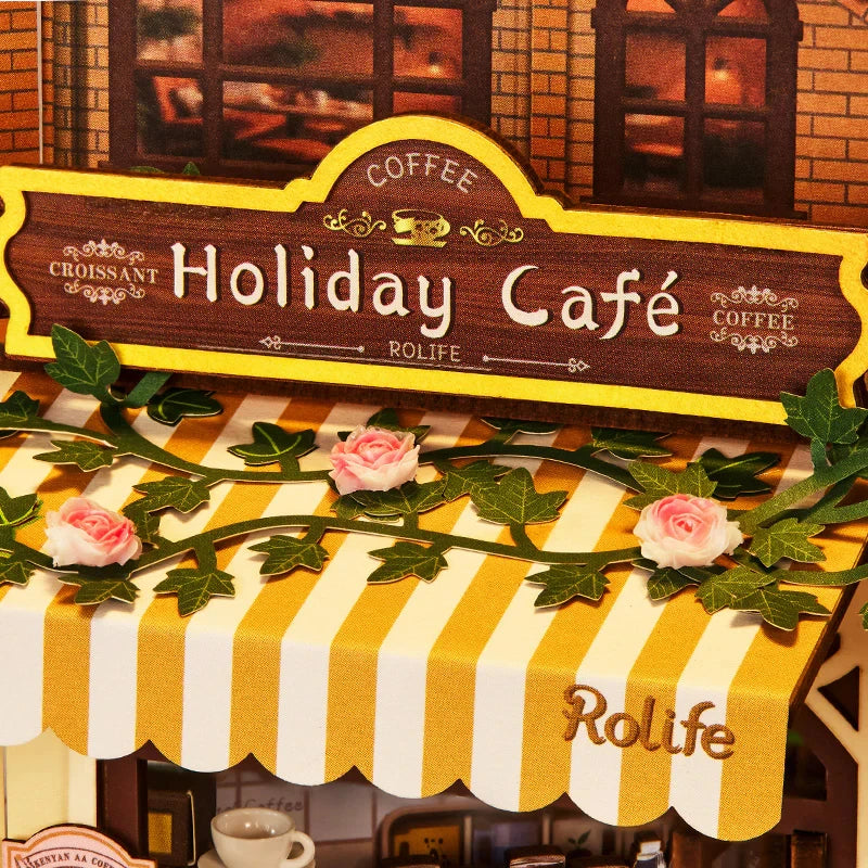 Enseigne Holiday Café et store rayé jaune garni de roses