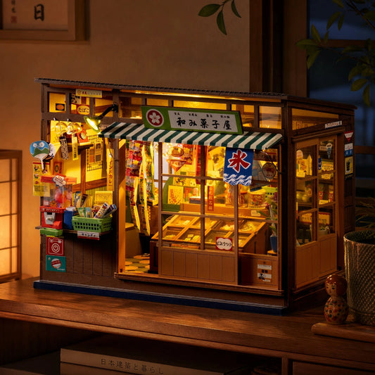 Book nook Nagomi Kashiya illuminé la nuit, posé sur un meuble en bois sombre, éclairage LED chaud