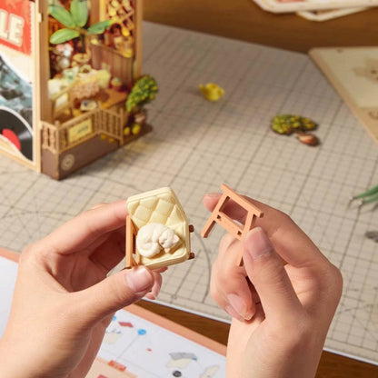 Montage du fauteuil miniature et du chat endormi du book nook Sunset Isle
