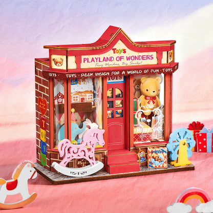 Whimsy Toy Shop dans un décor rose pastel, cheval à bascule rose et grande roue bleue