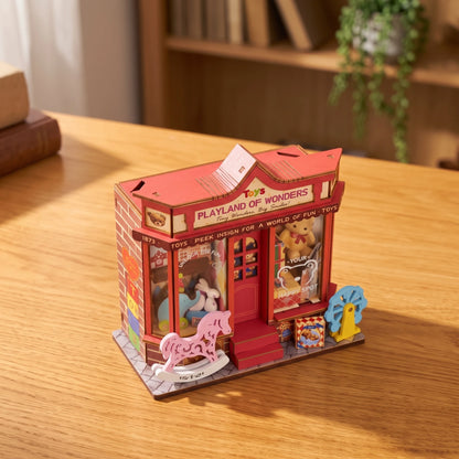 Vue plongeante sur la scène miniature Whimsy Toy Shop, toit rouge, pavés et cheval à bascule