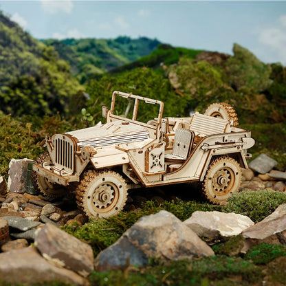 Jeep militaire en bois vue de face au milieu de mousse et de pierres