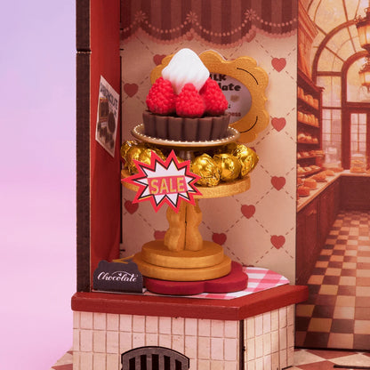Gâteau à la fraise sur présentoir doré dans la chocolaterie Sweet Chocolate Shop
