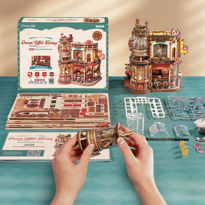 Montage du Dream Coffee Factory : planches de pièces, boîte et mains au travail
