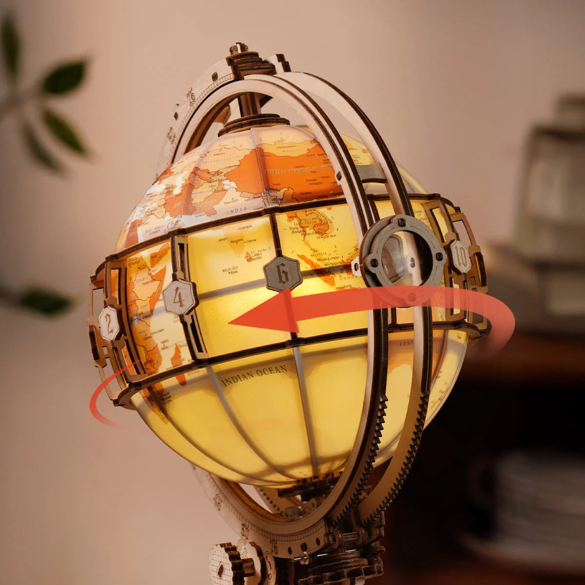 Gros plan du globe en rotation avec ses médaillons de fuseaux horaires