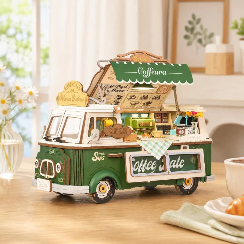 Leo's Coffee Truck sur une table lumineuse près d'un bouquet de marguerites